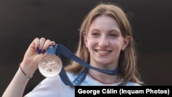Romanian gymnast Ana Maria Barbosu poses with her Olympic bronze medal in Bucharest on August 16.