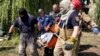 Rescuers remove the body of a woman killed by a Russian missile attack in Chuhuiv, in Ukraine's Kharkiv region, on July 26.