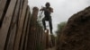 A member of the Ukrainian National Guard jumps into a trench at a position near the front line in the Kharkiv region on August 3.