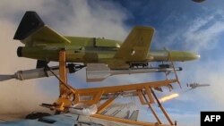 A drone carrying a missile is launched during a military drill at an undisclosed location in central Iran. (file photo)