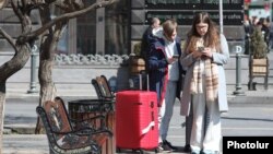 Armenia - Russian travellers read news on their mobile phones, Yerevan, March 7, 2022.