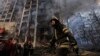 A firefighter works outside a destroyed apartment building after a bombing in a residential area in Kyiv on March 15.