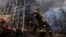 A firefighter works outside a destroyed apartment building after a bombing in a residential area in Kyiv on March 15.