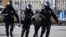 Russian police officers detain an anti-war protester in central Moscow on March 13. 