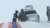 Rescue workers come to the aid of drivers stranded in Kazakhstan's Turkestan on January 3. 