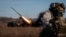 Ukrainian soldiers fire a Bureviy multiple-launch rocket system at a position in the Donetsk region on November 29.