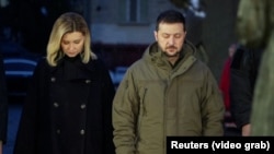 Ukrainian President Volodymyr Zelenskiy and his wife, Olena, pay their respects to the victims of the Holodomor famine at a memorial in central Kyiv on November 26. 