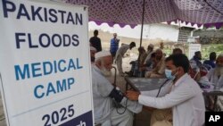 د بونېر په یو طبي کیمپ کې ډاکتر د یو سېلاب ځپلي د وینې فشار ګوري - د اګست ۱۷مې انځور.