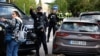 Police stand outside the Ukrainian Embassy in Madrid after a blast injured one employee while handling a letter on November 30.
