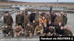 Ukrainian prisoners of war pose after a previous swap in the Zaporizhzhya region on November 24.