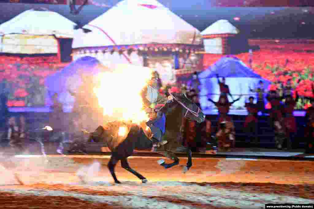 Ат үстүндө алоолонуп күйүп бара жаткан жоокер. Дал ушул театралдаштырылган көрүнүш буга чейинки Көчмөндөр оюндарында да көрсөтүлүп, көпчүлүктүн алкоосуна арзыган.&nbsp;