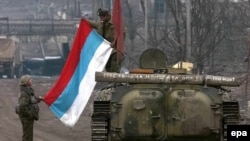 Соьлжа-ГIалара Оьрсийчоьнан эскархой, 2000-чу шеран чиллан-бутт. ТIеман машенна тIе йаздина ду: "И харц белахь а - сан даймохк бу!". Гайтаман сурт