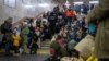 People shelter inside a subway station during massive Russian missile attacks on Kyiv on December 16. 