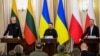 Ukrainian President Volodymyr Zelenskiy (center) at a joint press conference with Lithuanian President Gitanas Nauseda (left) and Polish President Andrzej Duda in Lviv on January 11. 