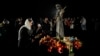 A woman lays flowers during a memorial for the victims of the Holodomor famine in Kyiv on November 26.