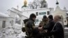 Ukraine's Security Service officers check the documents of visitors to the Kyiv Pechersk Lavra monastery on November 22 as part of a weeks-long, wide-ranging probe into suspected pro-Russia activity.