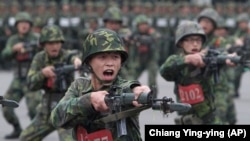 Täze gulluga alnanlar Taýwanyň demirgazygyndaky Sinçžu welaýatyndaky harby türgenleşik mekdebinde. Taýwan hökmany harby gullugy bes etmek we doly meýletin gulluga geçmek meselesi bilen ýüzbe-ýüz durýar. Häzir meýletinçiler ýeterlik däl. 2013-nji ýylyň 22-nji apreli.