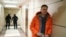 Aleksei Navalny stands in a hallway of a business centerthat houses the office of his Anti-Corruption Foundation in Moscow during a raid by law enforcement on December 26, 2019.