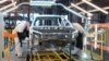 Russian employees work at the assembly line of the Lada Izhevsk automobile plant, part of the Avtovaz Group, in Izhevsk.