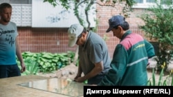 Комунальники у Запоріжжі, 25 травня 2022 року, коли російська ракета влучила в ТРЦ у спальному районі