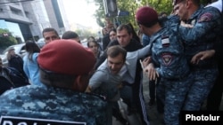 Armenia - Riot police detain an opposition protester in Yerevan, May 17, 2022.