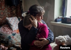 Бабуся Ольга обіймає свою 6-річну онуку Аріну, Бахмут