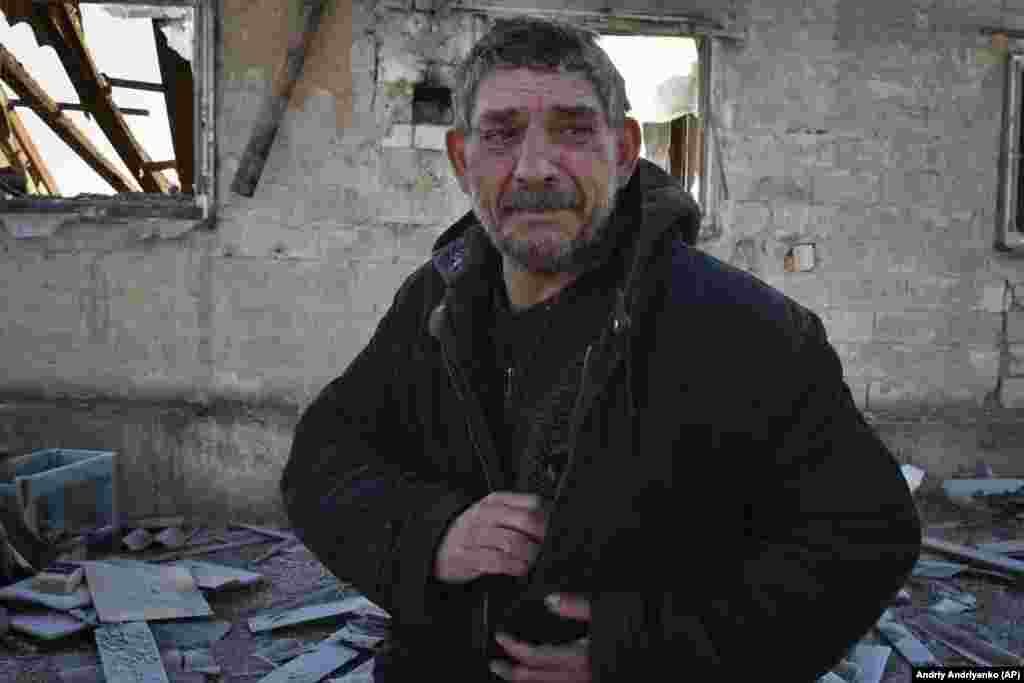 A Ukrainian man cries after his wife was killed when a Russian rocket destroyed their house in Zaporizhzhya on the night of January 25-26, 2023.&nbsp;