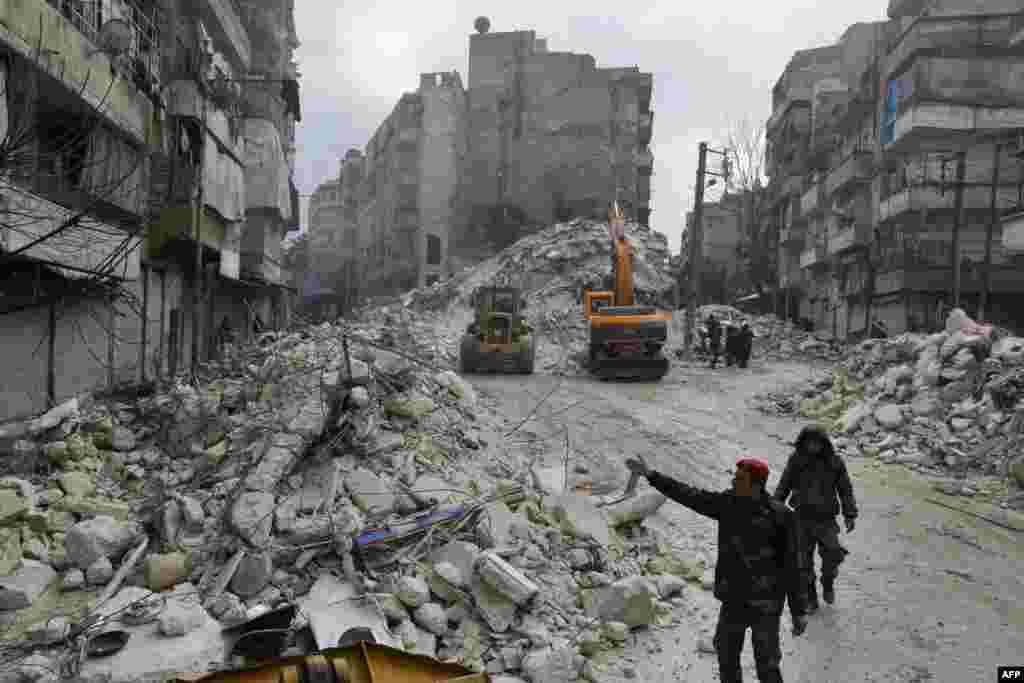 Сирийские спасатели ищут пострадавших и выживших в городе Алеппо