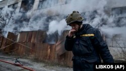A Ukrainian firefighter takes a break following Russian shelling that hit an industrial area in Kherson on February 5.