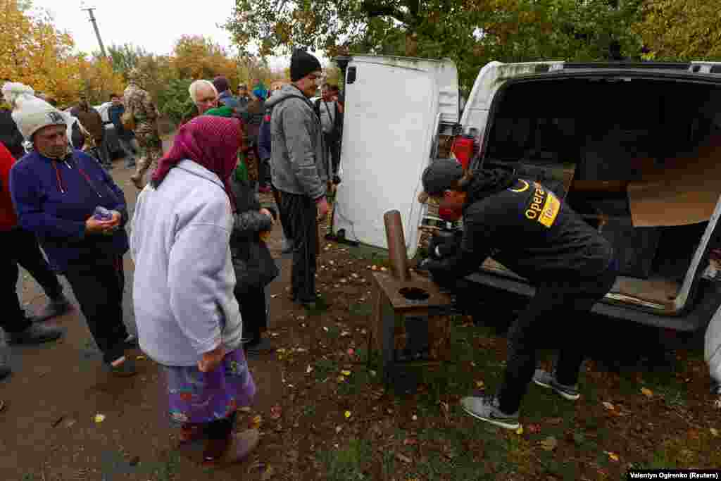 A volunteer from OperationAid hands out wood-burning stoves to residents at an undisclosed village in the Mykolayiv region on October 25.&nbsp; Ludvig Ramestam, one of the founders of the Swedish OperationAid charity, told RFE/RL that stoves are seen as increasingly crucial across Ukraine as Russia targets energy infrastructure. &quot;The winter is coming and I&#39;d say that only now in October we are beginning to see what will be waiting for us in Ukraine,&quot; he says.&nbsp; &nbsp;
