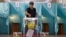 A woman casts her vote in the referendum at a polling station in Almaty on June 5.