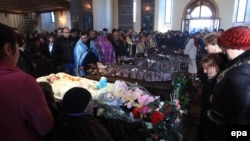 Mourners attend a funeral service for the slain family in the city of Gyumri on January 15.