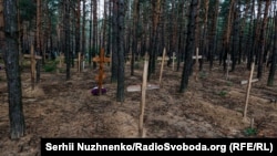 Изюм шаарынын жанындагы токойдогу сөөктөр жапырт көмүлгөн жай. 15-сентябрь, 2022-жыл.
