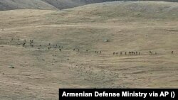 An image taken from a YouTube footage released by Armenian Defense Ministry on September 13, 2022, shows Azerbaijaniani servicemen crossing the Armenian-Azerbaijani border and approaching the Armenian positions. 