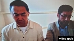 Qairat Satybaldy (left) in a Kazakh courtroom on September 20.