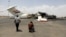 Media photographers take pictures of a destroyed plane at Sanaa International Airport in the aftermath of an Israeli airstrike earlier this month. 