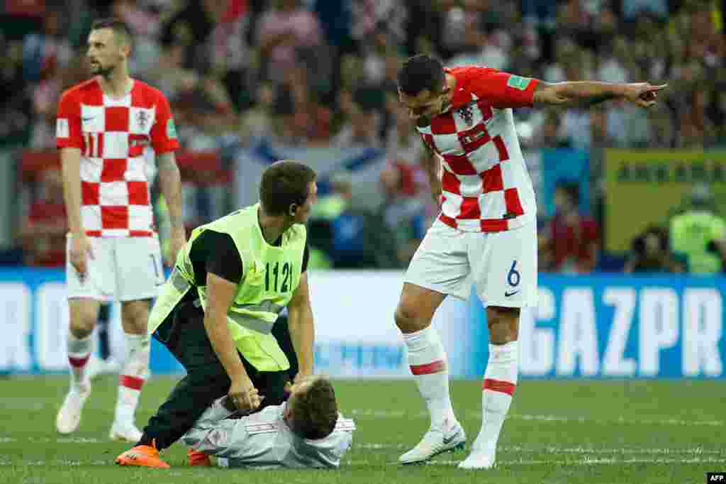 The four stormed the pitch as Croatia was making a drive toward goal.