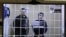 Two of the defendants, Vladimir Kalmykov (left) and Ishtimir Khudzhamov, take part in a virtual court hearing in Moscow. (file photo)