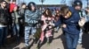 Police intervene against two young protesters at an anticorruption rally in central Moscow on March 26. 