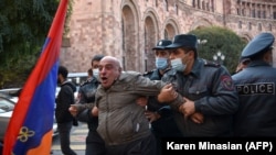  Armenian police officers detain a man near the government building in Yerevan protesting Prime Minister Nikol Pashinian's signing an agreement to end fighting with Azerbaijan over Nagorno-Karabakh , November 10, 2020.