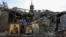 A woman collects Orthodox icons at the site of a church destroyed by a Russian missile strike in the village of Komyshuvakha on April 16.
