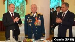 Russian President Vladimir Putin (left) congratulates Dmitry Yazov (center) on his 90th birthday in Moscow on November 8, 2014.