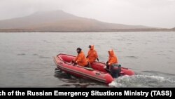 Russian Emergency Situations Ministry workers take water samples from waters by the village of Zavoiko on October 6. 
