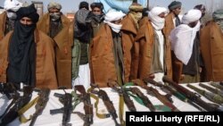 A group of 20 Taliban militants in Afghanistan's Herat Province give up their weapons on February 20.