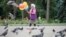 KAZAKHSTAN -- An elderly woman sells balloons in a park in Almaty, Kazakhstan June 28, 2017