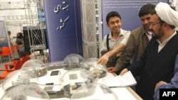 Студенттер даражалуу диниятчини Ирандын ядролук өнөр жайдагы жетишкендиктерине арналган көргөзмө менен тааныштырышууда.Шахид Бехешти университети, Тегеран. 20-апрель 2009