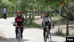Iran -- Women on bicycle in a park Iran, Apr2011