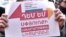 Armenia - A demonstrator in Yerevan holds a poster objecting to government plans to close the Ministry of Diaspora, December 25, 2018.