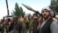 AFGHANISTAN -- Armed men attend a gathering to announce their support for Afghan security forces and that they are ready to fight against the Taliban, on the outskirts of Kabul, June 23, 2021