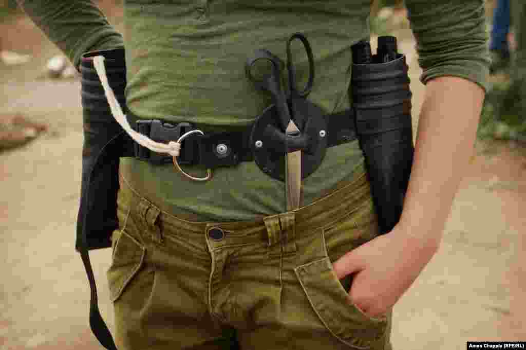 Didi Aaslund, a Dutch volunteer who helped design the bag and runs the class with Floor, shows off her toolbelt, made from the straps of a life jacket and the material and lifeline holder of a migrant boat.&nbsp;